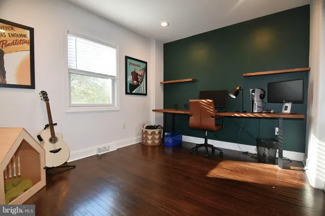 a workspace with wooden floor and windows