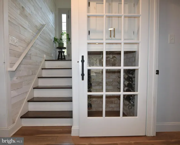 a view of staircase with wooden floor and windows