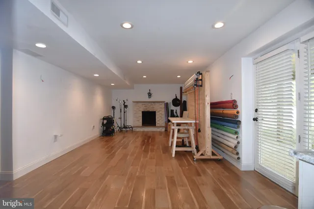 a view of a kitchen with furniture and wooden floor