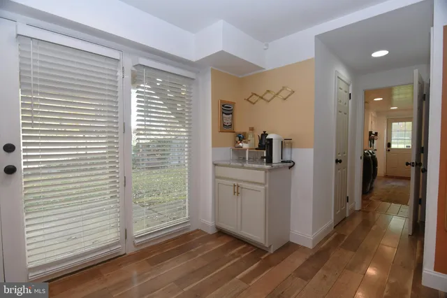 a view of a hallway with closet and wooden floor