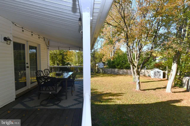 a view of back yard of the house with a patio