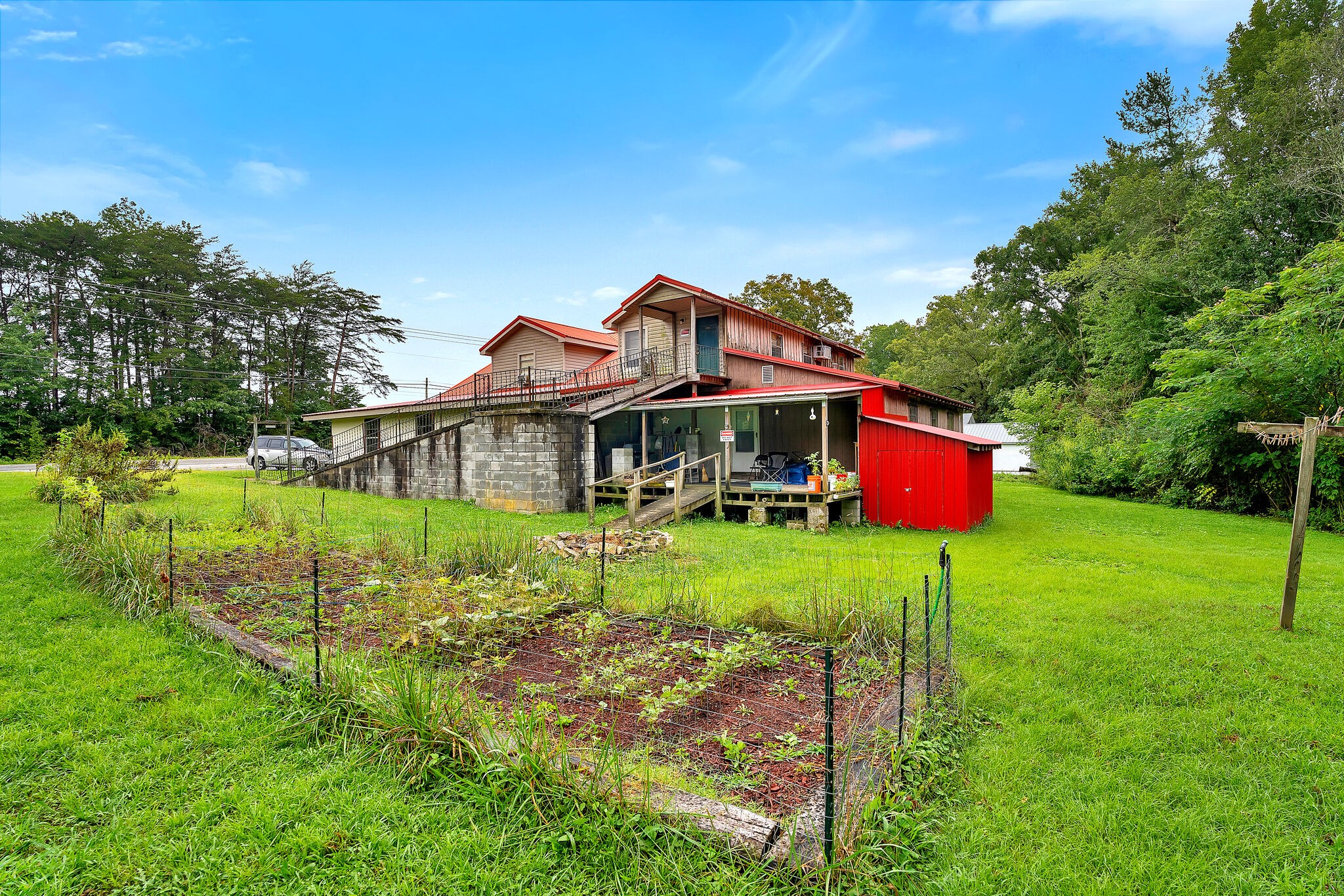 1205 Main Street Altamont, TN 37301 - Photo 44 of 51 a backyard of a house with table and chairs plants and large tree