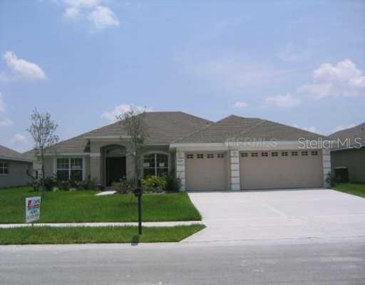 6005 Brick Road St. Cloud, FL 34772 - Photo 1 of 1 a front view of a house with a garden and yard