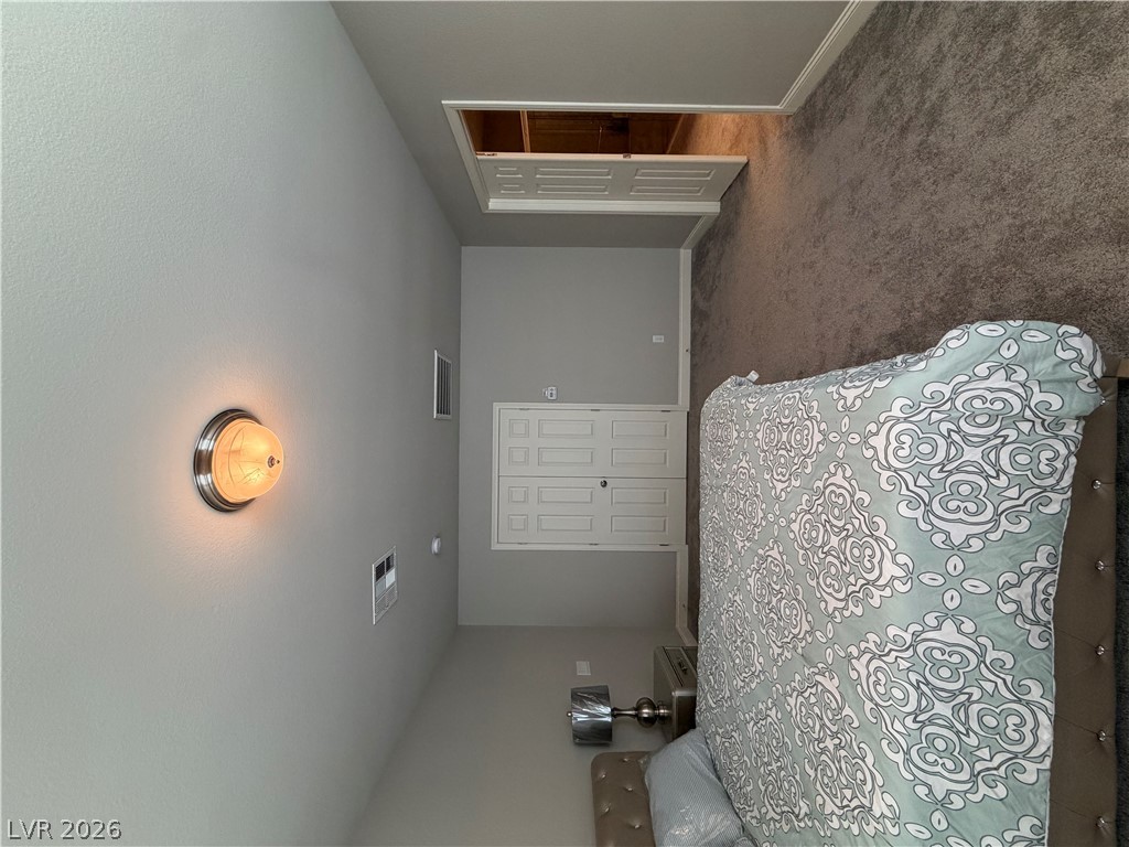 6385 Jackson Spring Road Las Vegas, NV 89118 - Photo 18 of 36 An inviting bedroom offers ample space, complete with plush carpeting and convenient closet access.