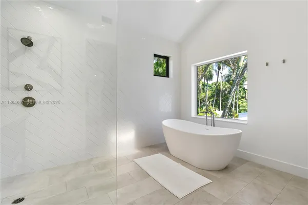 a bathroom with a bathtub and window