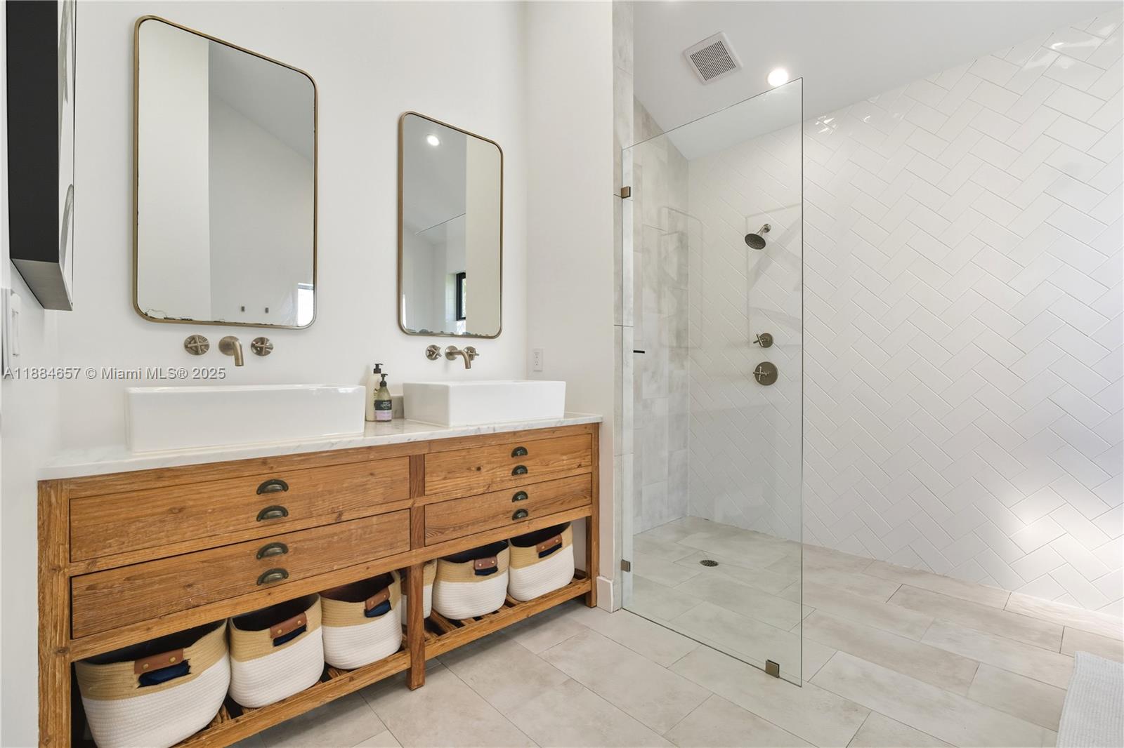 3782 El Prado Boulevard, Unit 1 Miami, FL 33133 - Photo 15 of 30 a bathroom with double sink and three mirror