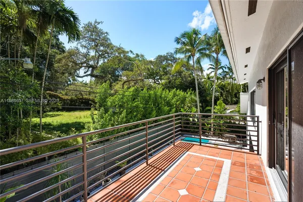 a view of balcony with small yard
