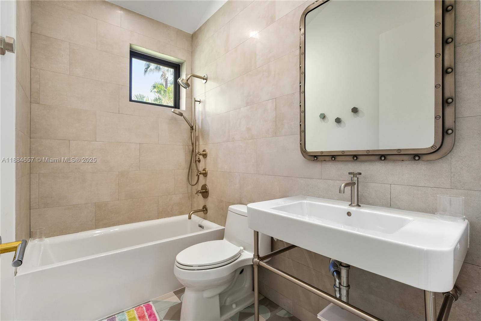 3782 El Prado Boulevard, Unit 1 Miami, FL 33133 - Photo 19 of 30 a bathroom with a sink a toilet and shower