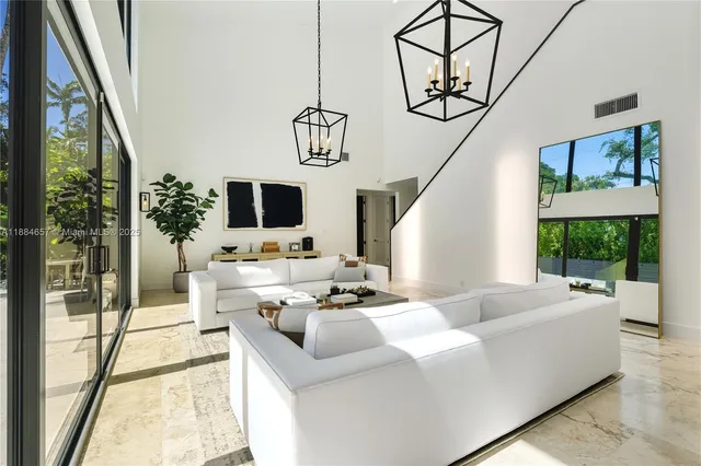a living room with furniture a flat screen tv and a floor to ceiling window