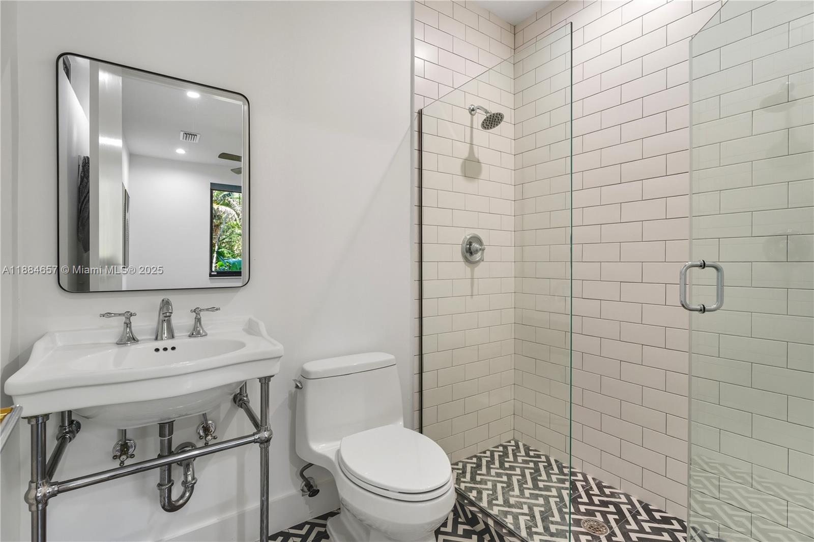 3782 El Prado Boulevard, Unit 1 Miami, FL 33133 - Photo 21 of 30 a bathroom with a sink a toilet and shower