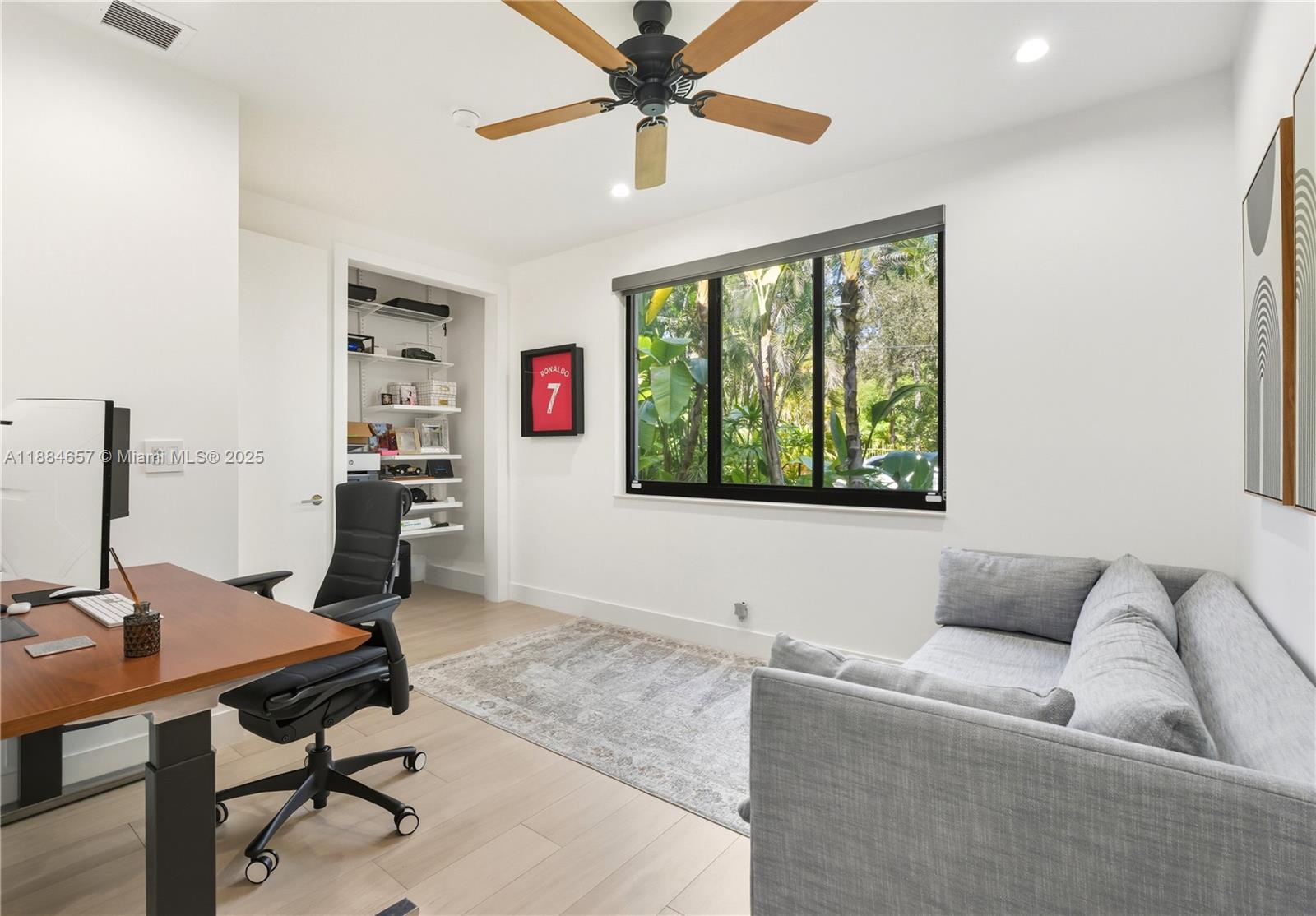 3782 El Prado Boulevard, Unit 1 Miami, FL 33133 - Photo 24 of 30 a living room with furniture and a window