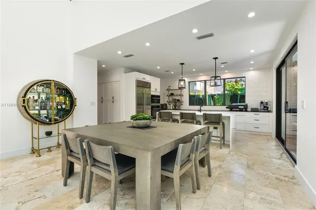 a kitchen with a table and chairs in it