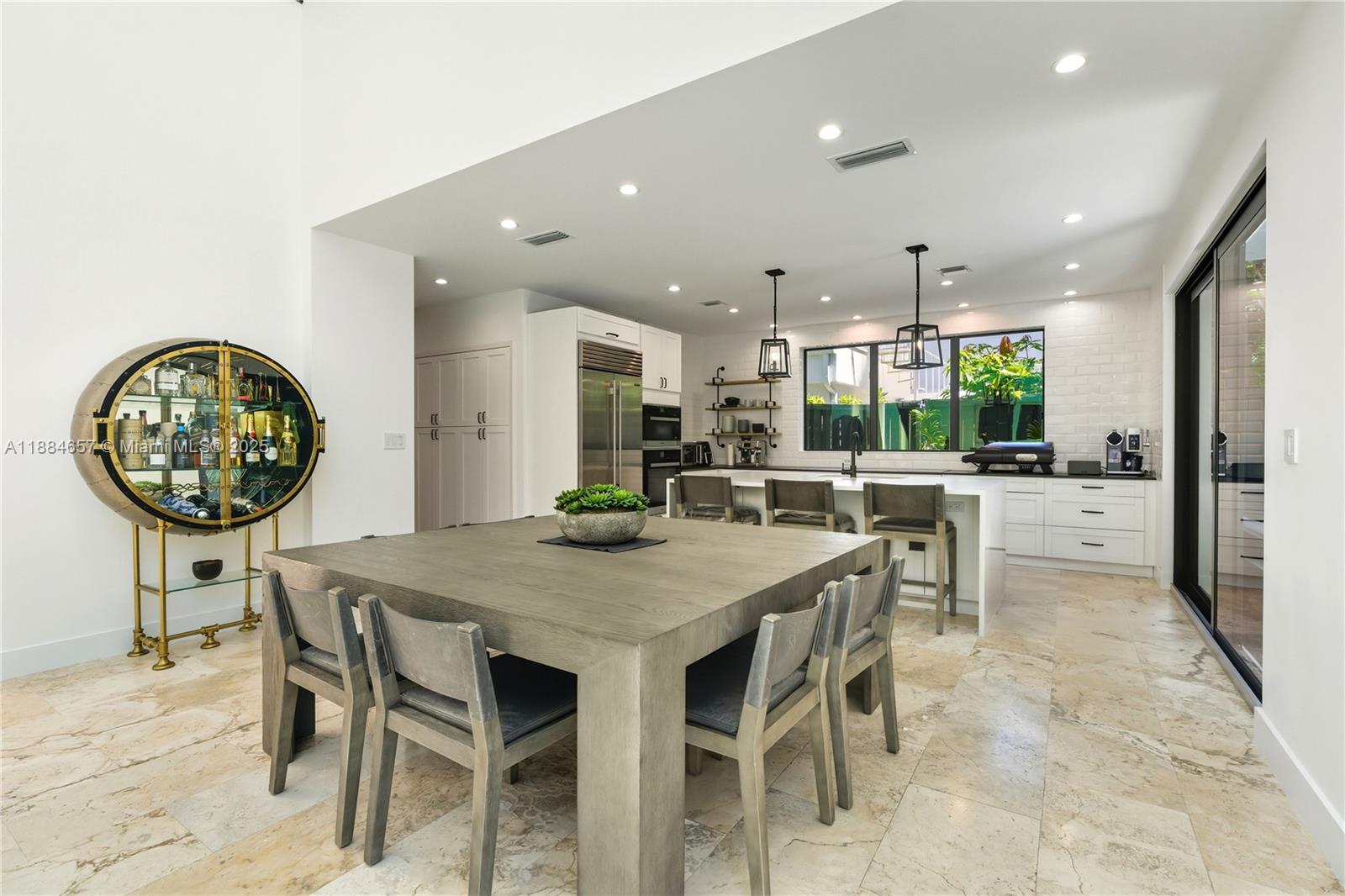 3782 El Prado Boulevard, Unit 1 Miami, FL 33133 - Photo 9 of 30 a kitchen with a table and chairs in it