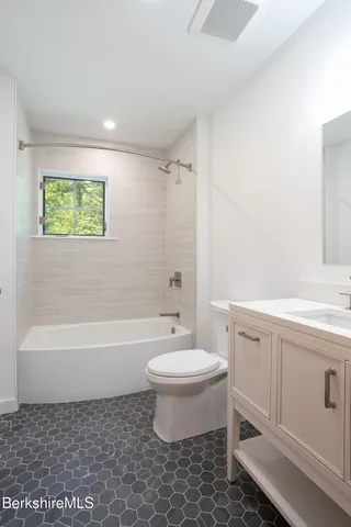 a bathroom with a sink a toilet and bathtub