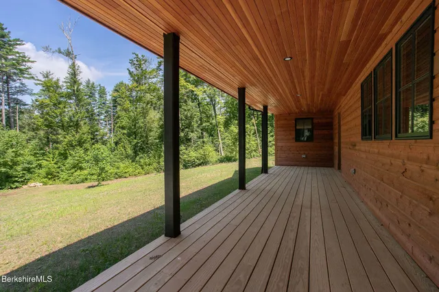 a view of a room with wooden floor and large window