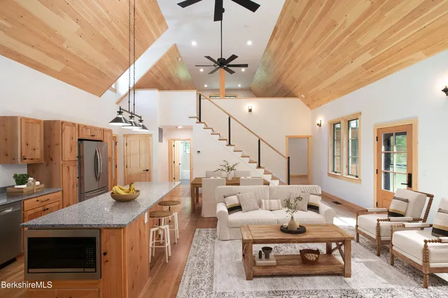 a living room with lots of furniture and chandelier