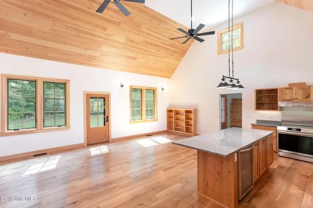 a view of a livingroom with furniture window wooden floor and a ceiling fan