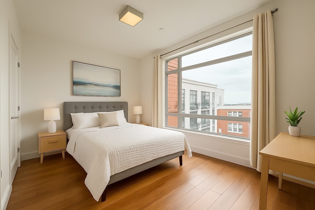 99 Sumner Street, Unit 606 Boston, MA 02128 - Photo 6 of 22 a bedroom with a large bed and a large window
