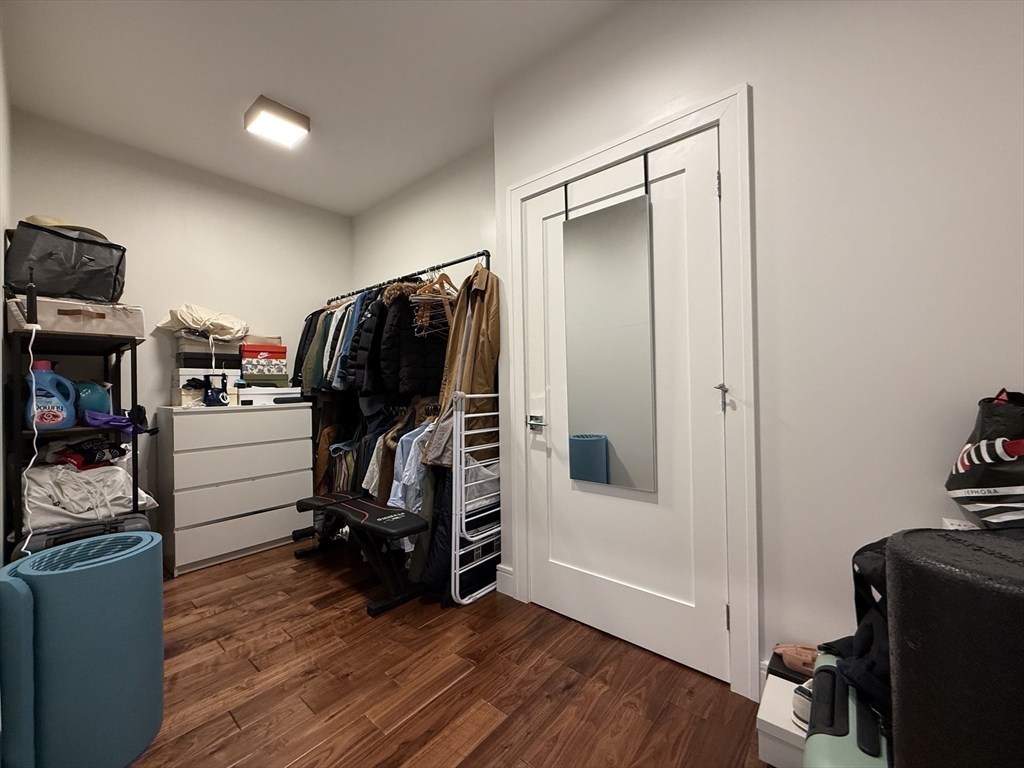 99 Sumner Street, Unit 606 Boston, MA 02128 - Photo 7 of 22 a view of walk in closet with clothes and shoes