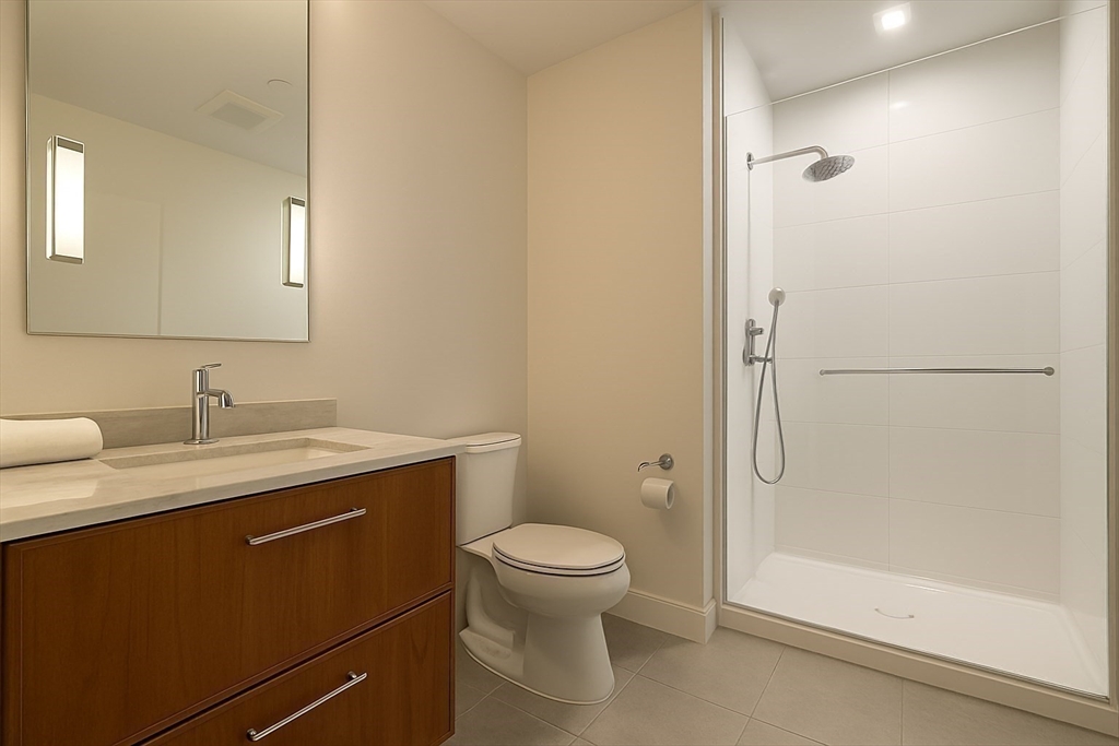 99 Sumner Street, Unit 606 Boston, MA 02128 - Photo 8 of 22 a bathroom with a granite countertop sink toilet and shower
