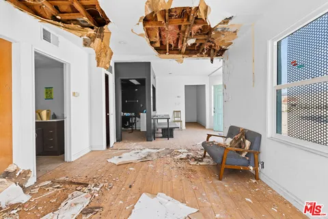 a living room filled with furniture and a chandelier