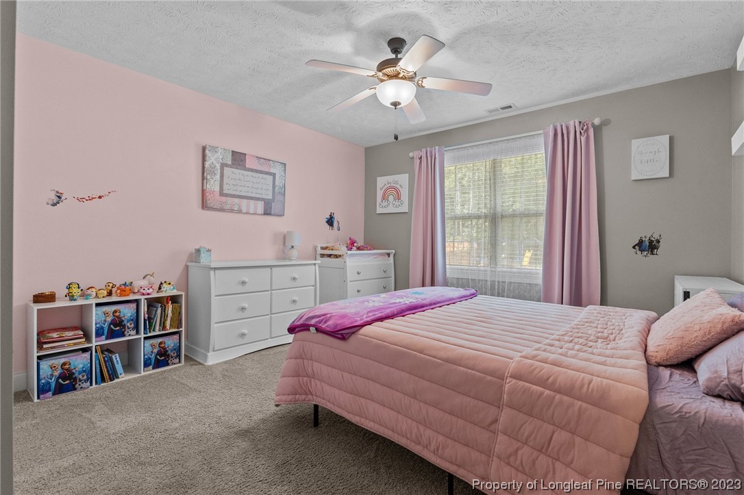 155 Dicks Hill Road Carthage, NC 28327 - Photo 25 of 47 a bedroom with a bed cabinets and window