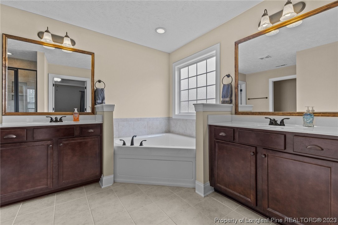 155 Dicks Hill Road Carthage, NC 28327 - Photo 32 of 47 a spacious bathroom with a tub double sink and mirror
