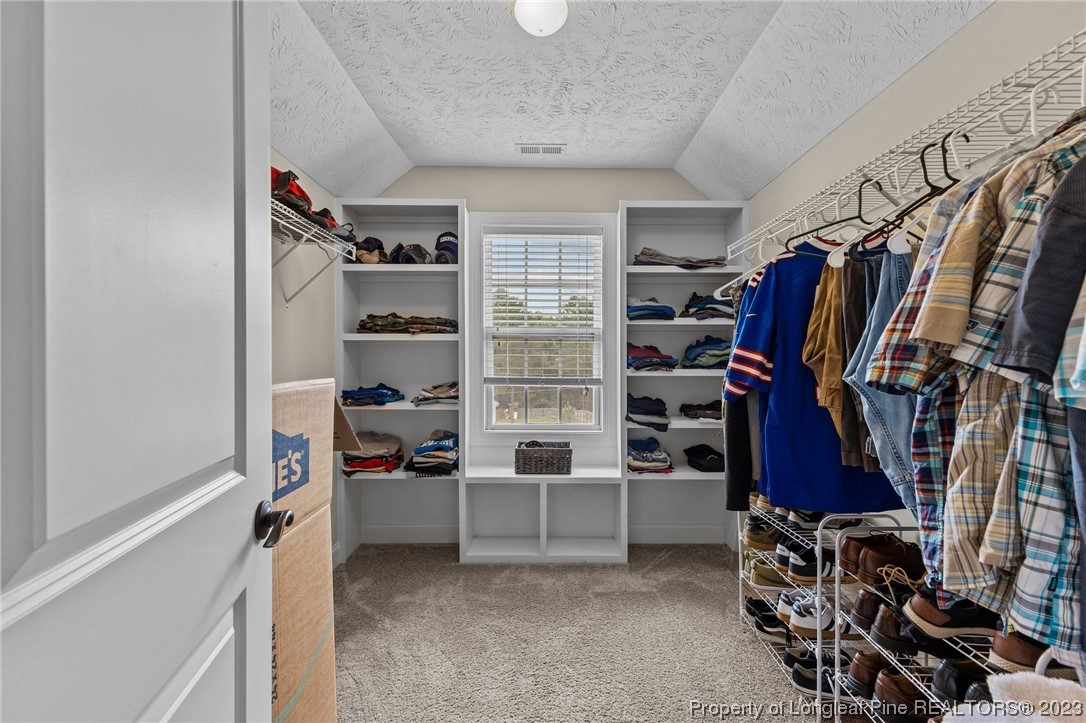 155 Dicks Hill Road Carthage, NC 28327 - Photo 34 of 47 a view of walk in closet with clothes and shoes