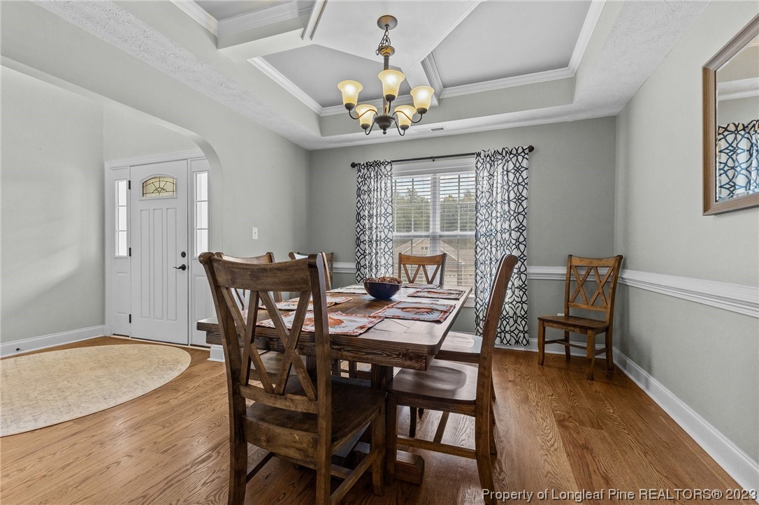 155 Dicks Hill Road Carthage, NC 28327 - Photo 8 of 47 a dining room with furniture a chandelier and wooden floor