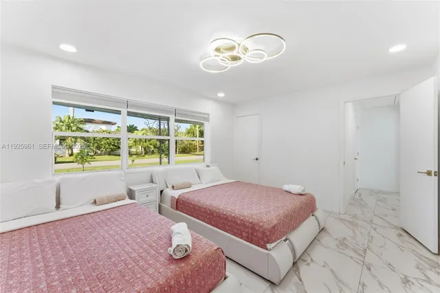 a spacious bedroom with a bed and a large window