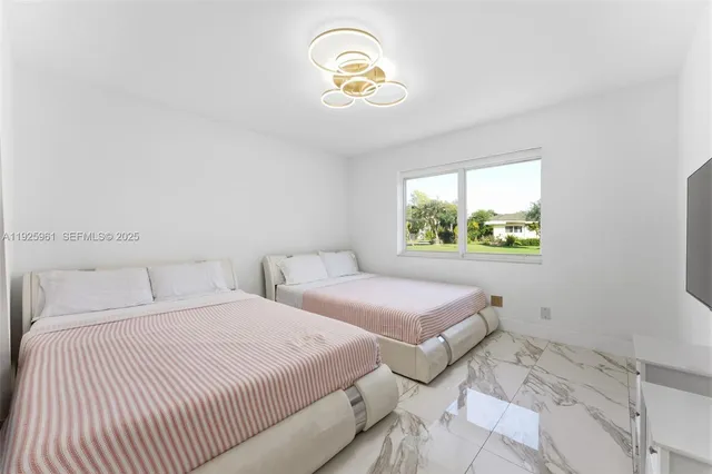 a bedroom with two beds and a window