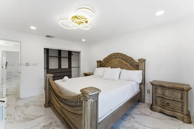 a bedroom with a bed and a dresser