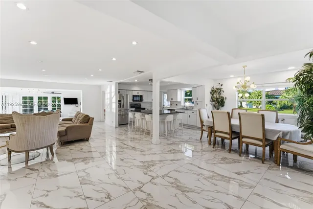 a dining room with furniture and view of kitchen