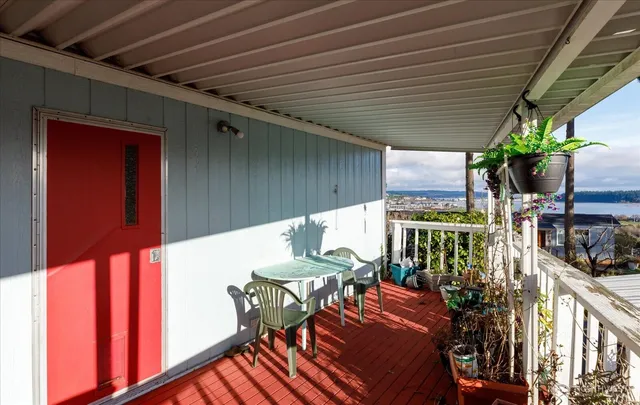 a balcony with furniture and potted plants