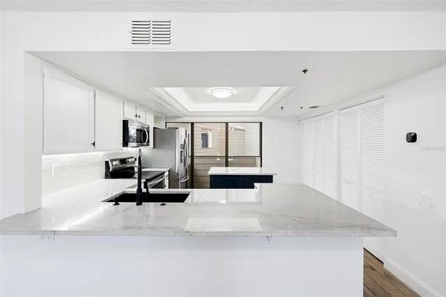 a large bedroom with a bed and a large window