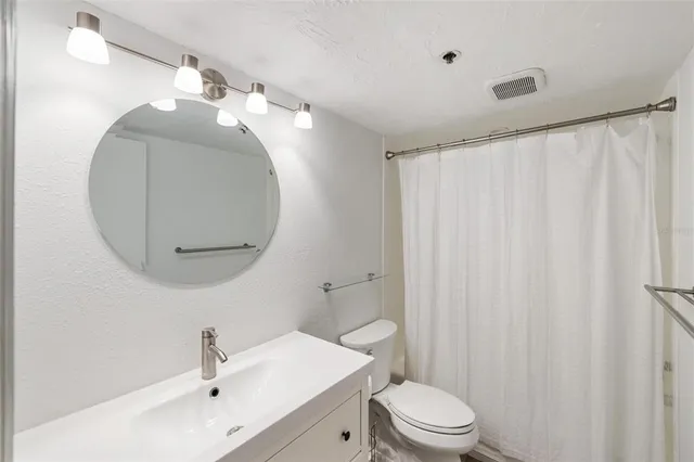 a bedroom with a bed and a potted plant