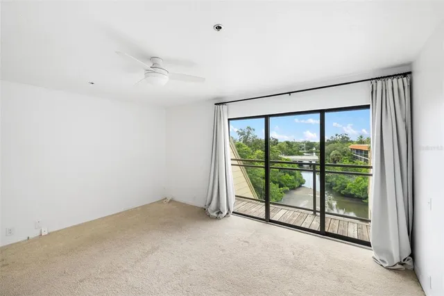 a street view with tall buildings and a yard