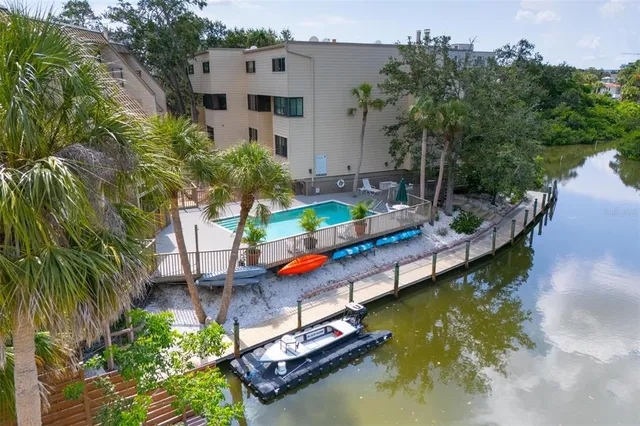 an aerial view of a house with swimming pool patio and lake view