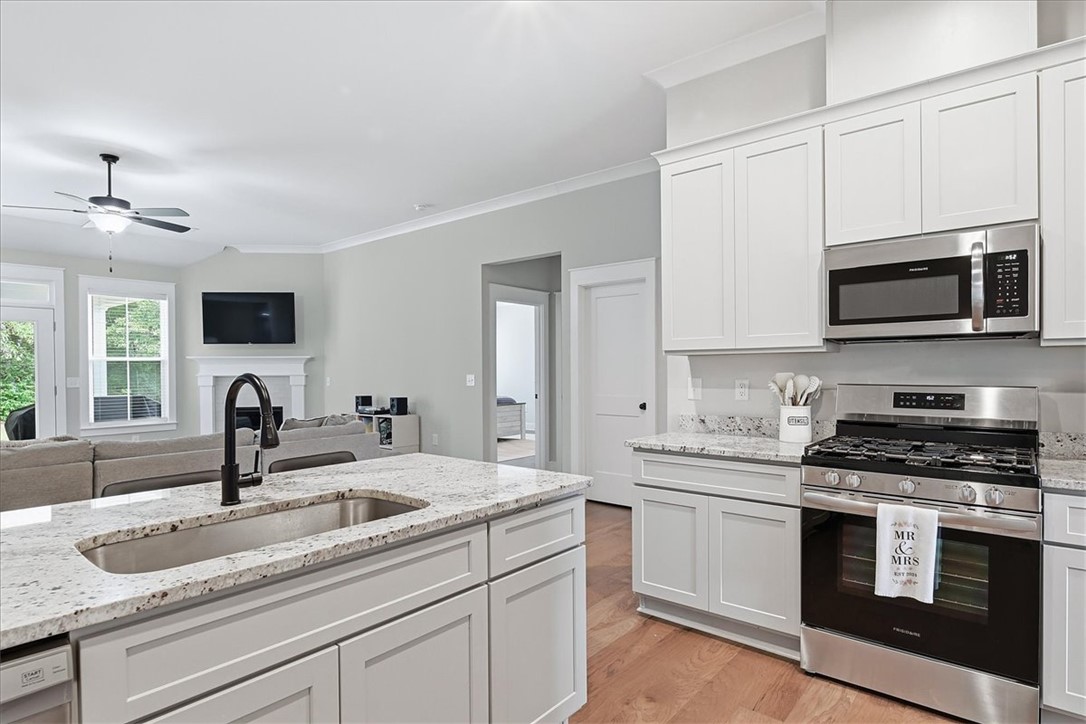 214 Timothy Court Anderson, SC 29621 - Photo 11 of 43 Culinary delights await in this bright kitchen, showcasing an island with a sink and ample counter space.