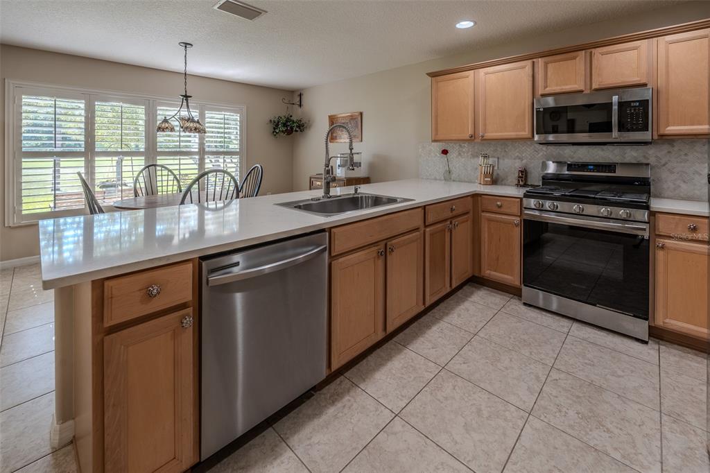 16023 Southwest 14th Avenue Road Ocala, FL 34473 - Photo 11 of 57 a kitchen with stainless steel appliances granite countertop a stove sink microwave and window