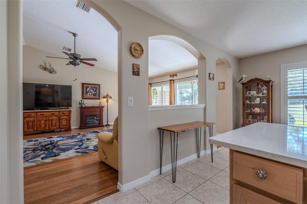 16023 Southwest 14th Avenue Road Ocala, FL 34473 - Photo 17 of 57 a view of a kitchen with furniture and a ceiling fan