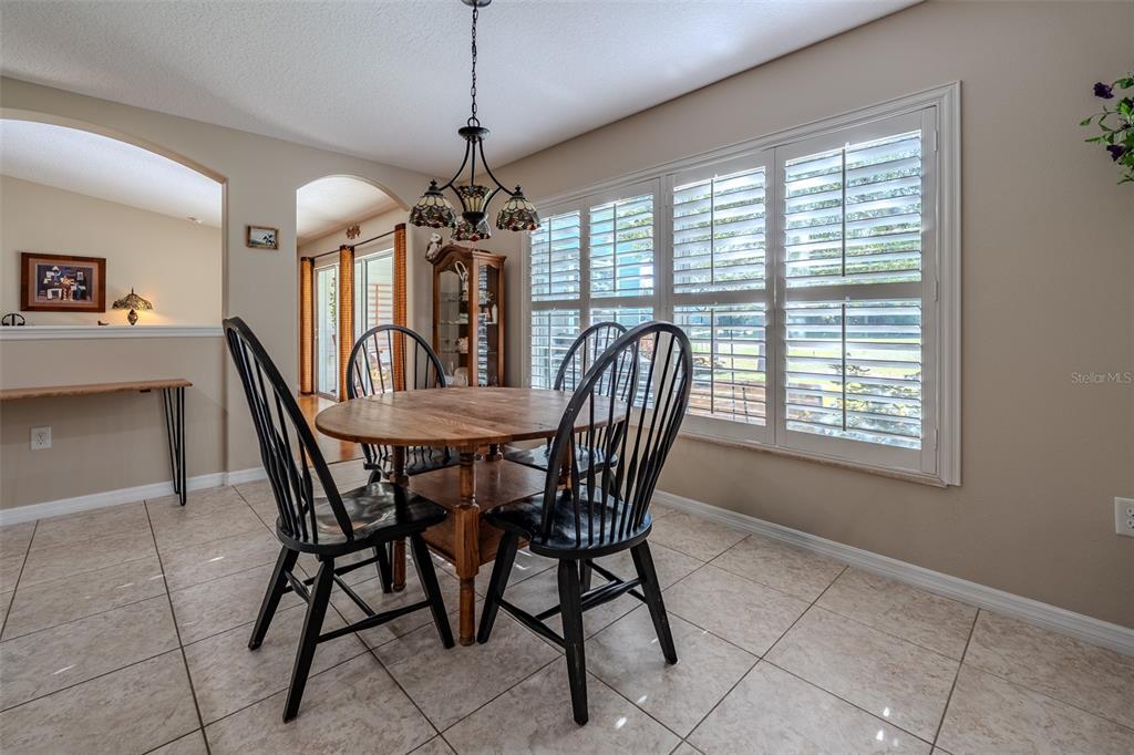16023 Southwest 14th Avenue Road Ocala, FL 34473 - Photo 23 of 57 a view of a dining room with furniture window and outside view