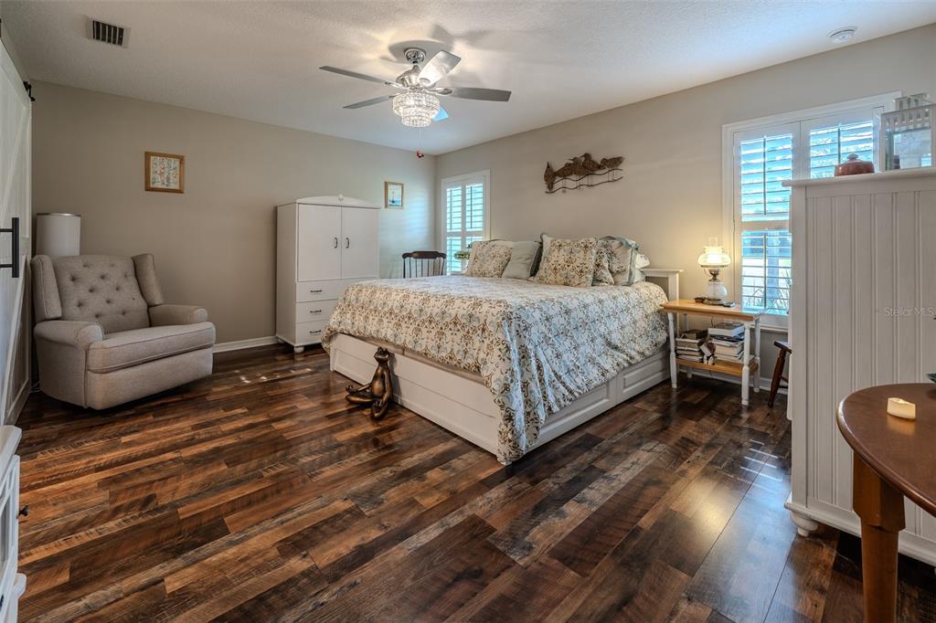 16023 Southwest 14th Avenue Road Ocala, FL 34473 - Photo 24 of 57 a spacious bedroom with a bed and a couch
