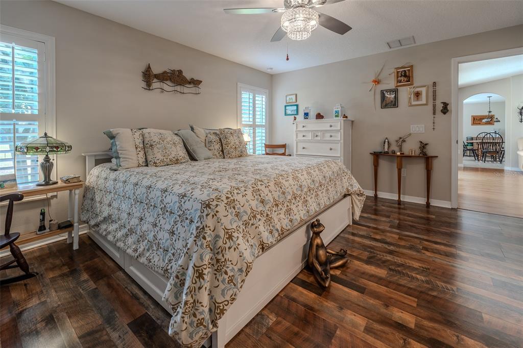 16023 Southwest 14th Avenue Road Ocala, FL 34473 - Photo 25 of 57 a bed room with a bed and a chandelier
