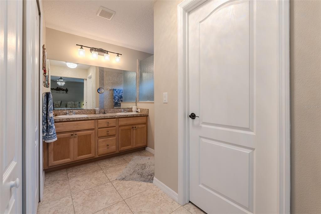 16023 Southwest 14th Avenue Road Ocala, FL 34473 - Photo 27 of 57 a bathroom with a granite countertop sink mirror and cabinets