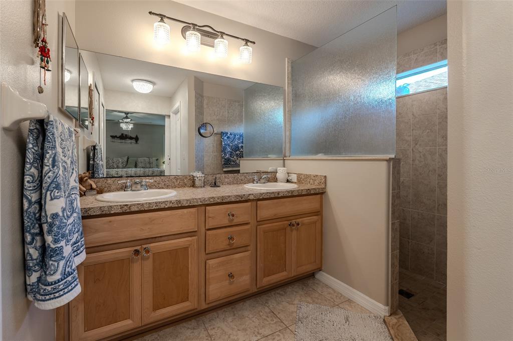 16023 Southwest 14th Avenue Road Ocala, FL 34473 - Photo 28 of 57 a bathroom with a double vanity sink and a mirror