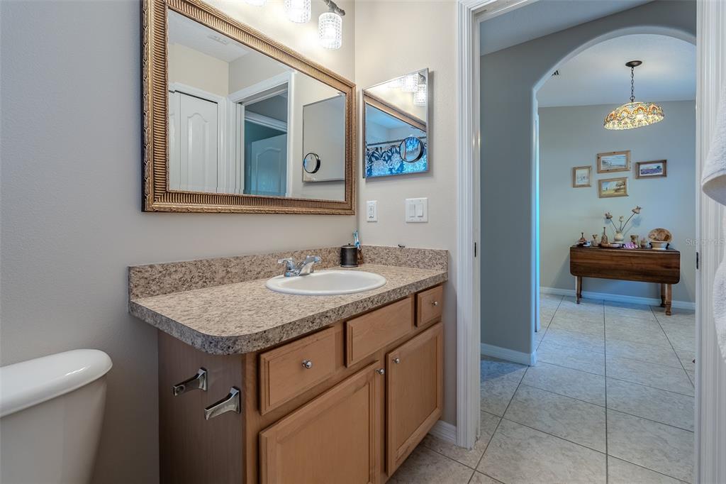 16023 Southwest 14th Avenue Road Ocala, FL 34473 - Photo 36 of 57 a bathroom with a granite countertop sink and a mirror