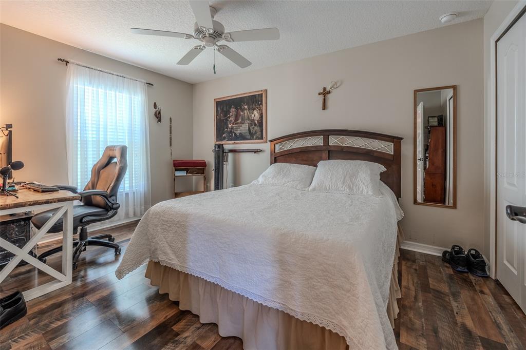 16023 Southwest 14th Avenue Road Ocala, FL 34473 - Photo 37 of 57 a bedroom with a bed and a table in it