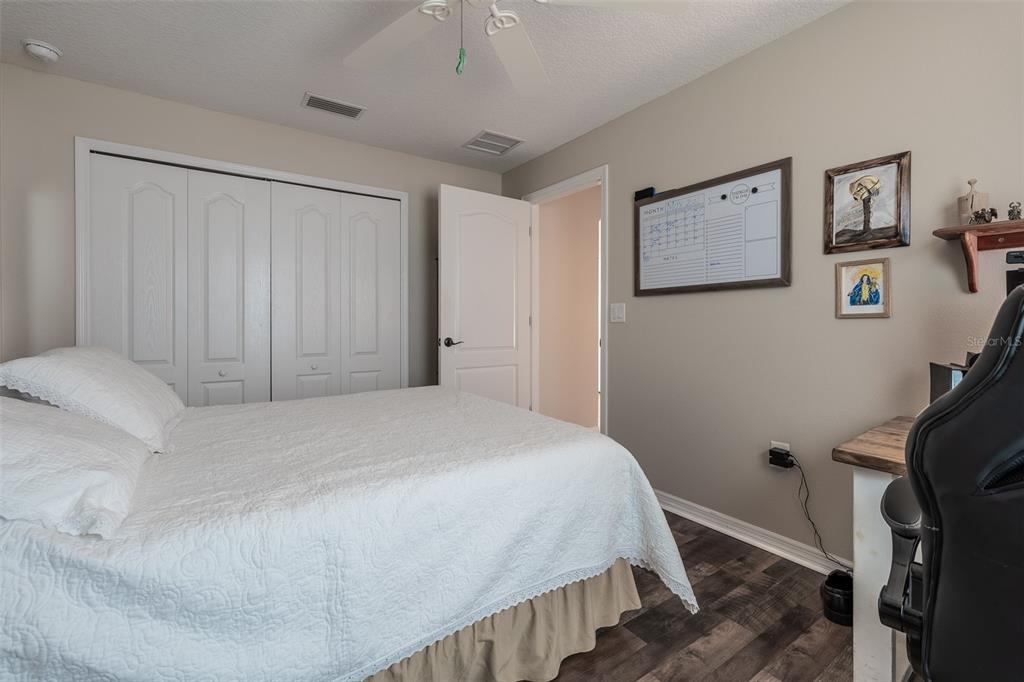 16023 Southwest 14th Avenue Road Ocala, FL 34473 - Photo 38 of 57 a bedroom with a bed and a flat tv screen on the dresser