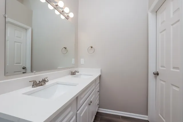 a bathroom with a sink a vanity and a mirror